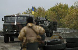 Ukrainian military vehicles pass a checkpoint near the eastern Ukrainian town of Debaltseve
